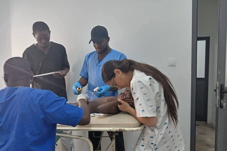 Una volontaria affianca il personale sanitario durante una medicazione in reparto